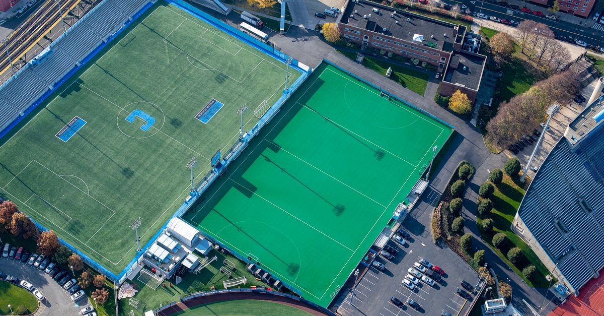 Aerial view of soccer and hockey fields in a city stadium complex.